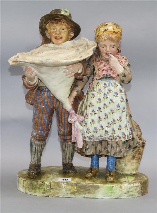 A Continental pottery group of a boy and girl height 46cm